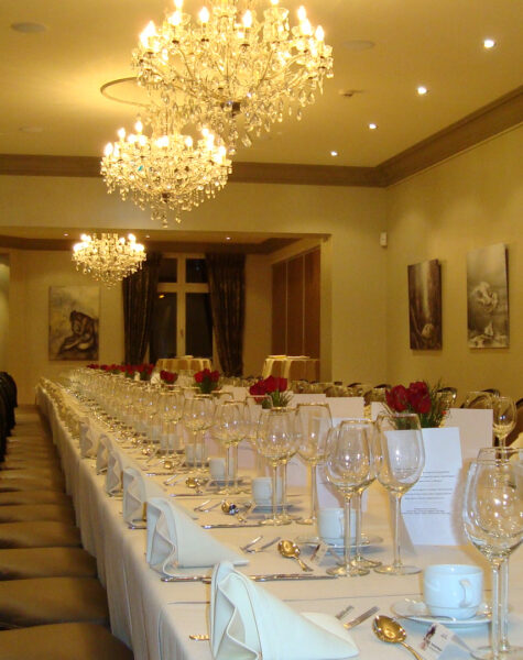 Room one decorated with a long table for a banquet