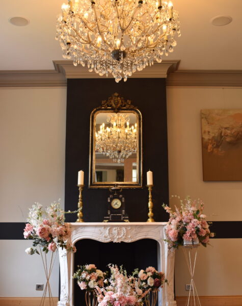 The mantelpiece of room 2a decorated with wedding flowers